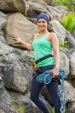 Attractive female rock climber smiling at camera Stock Photos