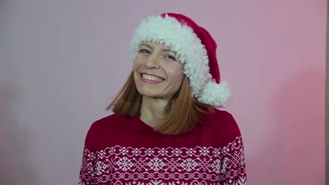 Attractive female in Santa hat celebrating Christmas. Stock Footage 163843653