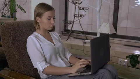 Attractive female typing on computer in cosy room Stock Footage 112083645