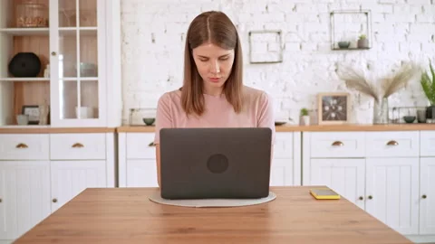 Attractive female using computer in flat Video stock 166686593