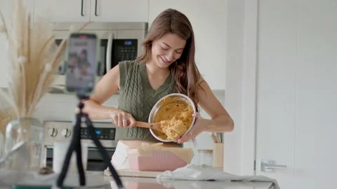 Attractive female vlogger baking fall loaf in apartment 库存影片 219403838
