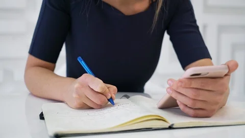 Attractive female writing in notepad Stock Footage 103042029