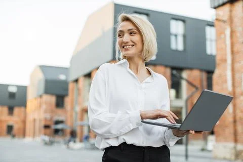 Attractive freelancer using portable computer for remote work Foto stock