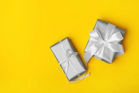 Attractive gift on the yellow background. Stock Photos