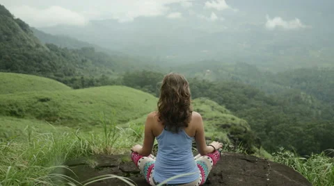 Attractive girl from behind meditating on top of mountain Stock Footage 59674092
