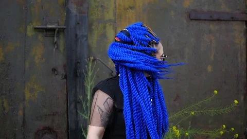 Attractive girl with blue dreadlocks dancing on the street, shaking dreadlocks Stock Footage 78096328