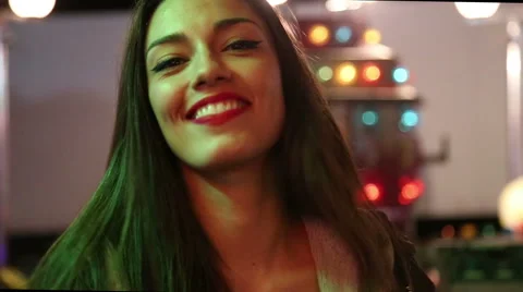 Attractive girl dancing in amusement park, sending kiss to the camera Stock Footage 59556199