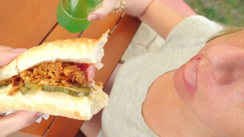 An attractive girl eats fresh pita bread with a salad of fresh vegetables and Stock Footage 80472385