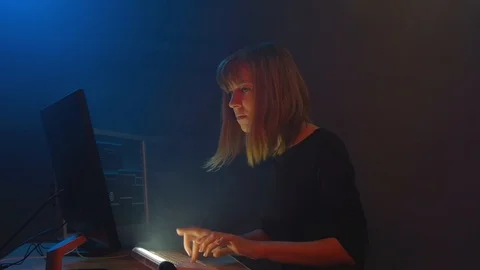Attractive girl hacker programmer is working on computer in underground office Stock Footage 90073566