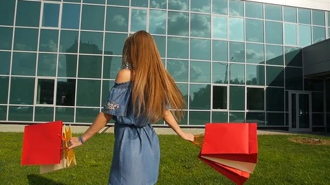 Attractive girl is holding shopping bags Stock Footage