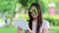 Attractive girl looks photos on tablet pc HD Footage
