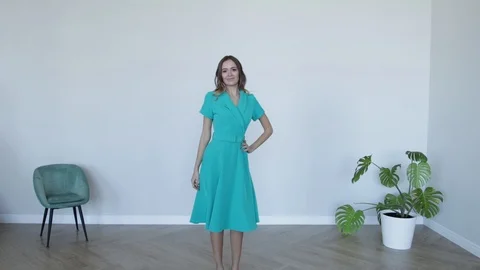 Attractive girl model posing smiling in gray dress. Stock Footage 107829791