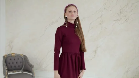 Attractive girl model posing smiling in a dress.Slow motion Stock Footage 129417763