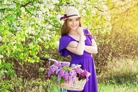 Attractive girl on an old-fashioned retro bike. Stock Photos
