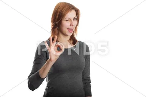 Attractive girl showing okay gesture Stock Photos