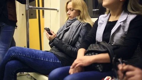 Attractive girl in subway train using smartphone. Young woman browse the Stock Footage 76497645