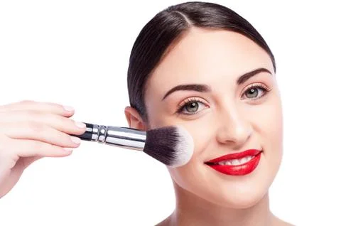 Attractive girl is using make-up brush Stock-Fotos