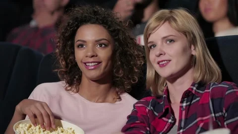 Attractive girlfriend smiling while watching movie 스톡 동영상 252655302