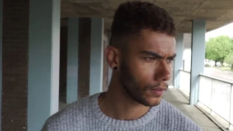 Attractive good looking aggressive mixed race black man council estate pan up 스톡 동영상 76299906