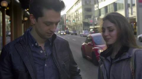 Attractive guy attempts to retreive something from his pocket Stock Footage 62465055