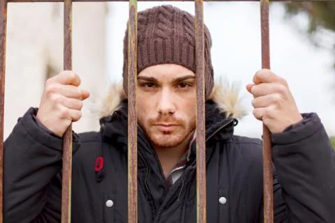 Attractive guy behide the bars Stock Photos