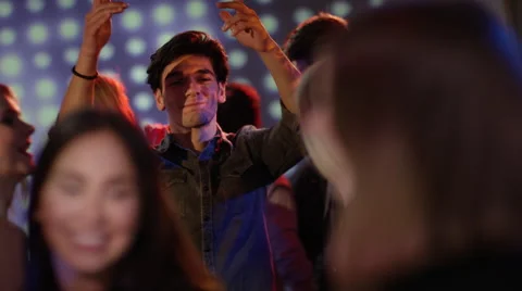 Attractive guy dancing at club looking at girls Stock Footage 61646768