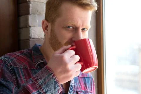 Attractive guy drinking coffee. Stock Photos