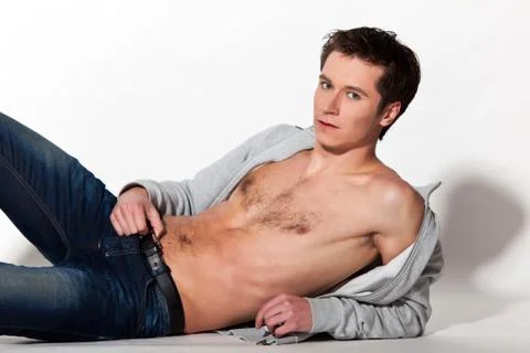Attractive guy posing on white background Фото