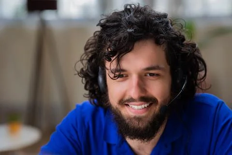 Attractive guy using the laptop he working online from home he take off the Stock Photos