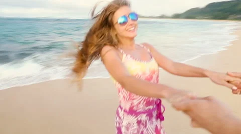 Attractive healthy couple having fun being together running on beach Stock Footage 58166654