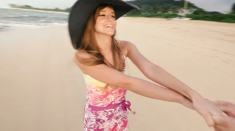Attractive healthy couple having fun being together running on beach Stock Footage 58166967