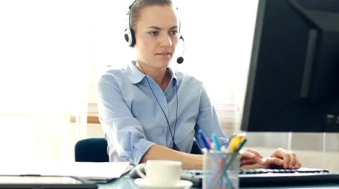 Attractive helpdesk consultant talking on headset HD Stock Footage 8600172