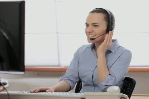 Attractive helpdesk consultant talking on headset NTSC Stock Footage 22021009