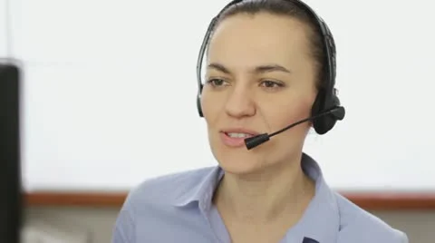 Attractive helpdesk consultant talking on headset, close up HD Stock Footage 22021836