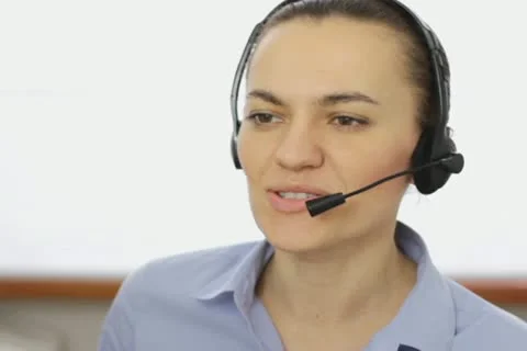 Attractive helpdesk consultant talking on headset, close up NTSC Stock Footage 22021900