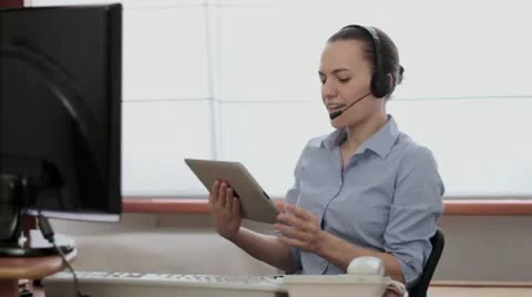 Attractive helpdesk consultant working on tablet computer HD Stock Footage 22021466