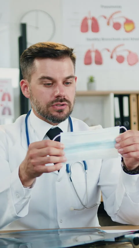 Attractive high-skilled successful 35-aged bearded doctor sitting at his workpla Stock Footage 327604331
