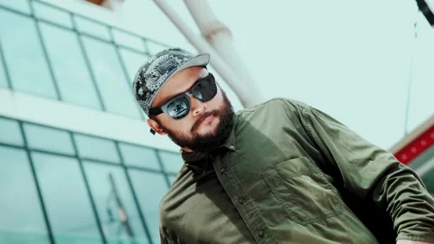 Attractive hipster looking at camera while dancing at sky scrapper. hiphop. Stock Footage 275088285