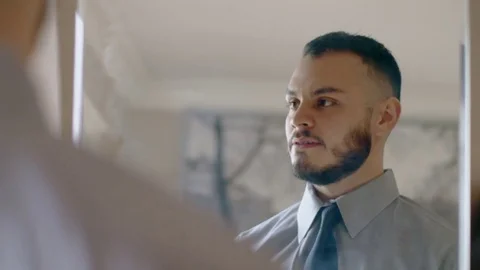 Attractive hispanic man practicing speech in mirror Stock Footage 84484304