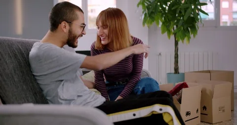 Attractive Hispanic young couple communicating together resting on sofa after Video stock 123666216