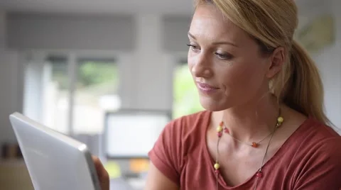 Attractive home-office woman working on digital tablet Stock Footage