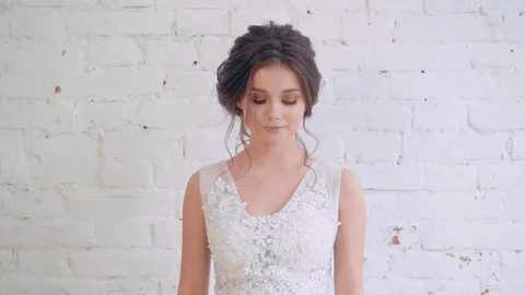 Attractive image of dark-haired bride with neat, gentle hairstyle, goes and Stock Footage 100287759