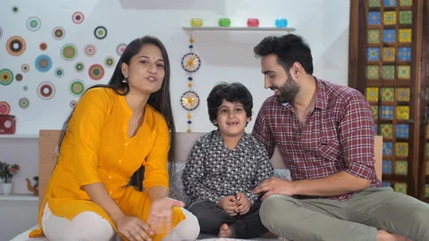 An attractive Indian couple smiling while talking on a video call at home - I... Stock Footage 170103932