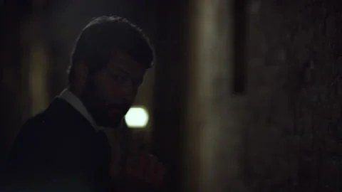 Attractive Italian model posing his outfit and walking down a dark alleyway at n Stock Footage 199453082