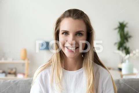 Attractive joyful millennial woman smiling looking at camera Stock Photos