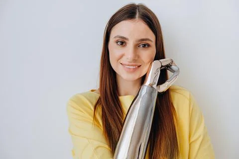 Attractive lady with bionic prosthesis arm looks into camera Foto stock