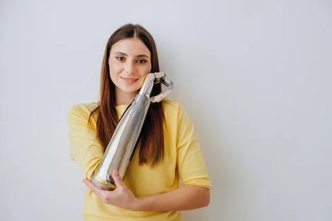 Attractive lady with bionic prosthesis arm looks into camera Foto stock