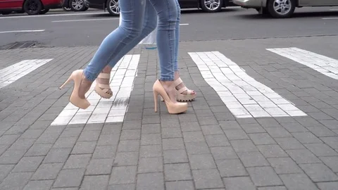 Attractive legs in high heels walking across the street in the city Stock Footage 78379048