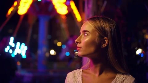 Attractive long-haired blonde young caucsian girl happily smiles look to camera Stock Footage 99672247
