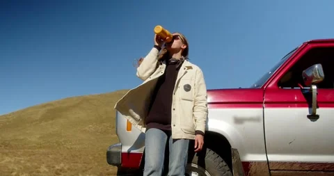 Attractive long-haired girl drinking a drink from a thermos of thermo mugs while Stock Footage 245897302